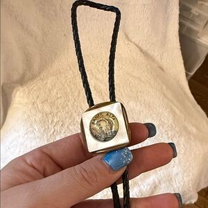 Banff Alta Bolo Tie Marlin Logo Black Leather Cord and Gold Tone Accents